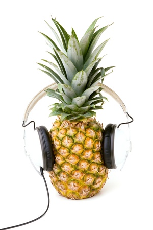 A fresh ripe pineapple wearing headphones isolated over a white background.の写真素材