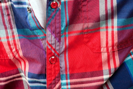 Close up detail of a red plaid button up style shirt.の写真素材