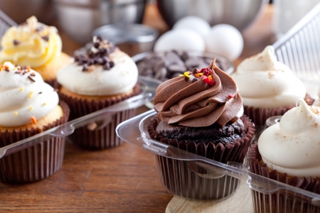 Close up of some decadent gourmet cupcakes frosted with a variety of frosting flavors.の写真素材