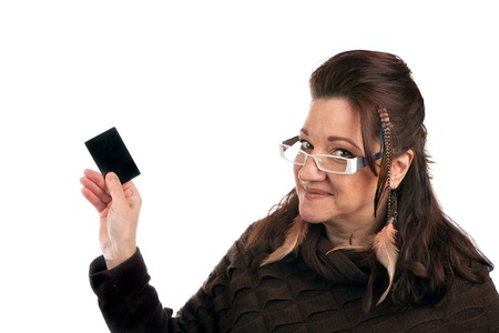 Brunette woman holding up a blank credit card business card shoppers club card or gift card of some...