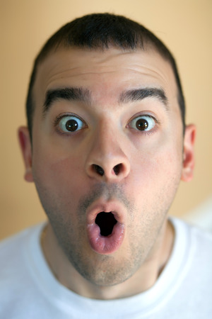 Shocked or surprised middle aged man who just heard some scary or astonishing news.の写真素材