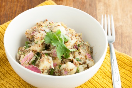 Potato salad freshly homemade without mayonaise.  Ingredients include cilantro olive oil vinegar whole grain dijon mustard red onions and potatoes.の写真素材