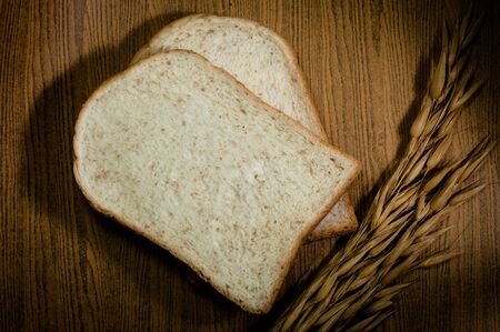 sliced grain bread on wood texture backgroundの写真素材