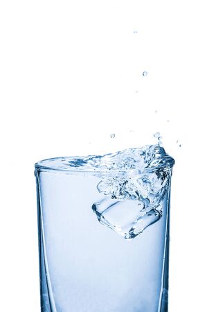 Drop Ice cubes into water, water splashing from glassの写真素材