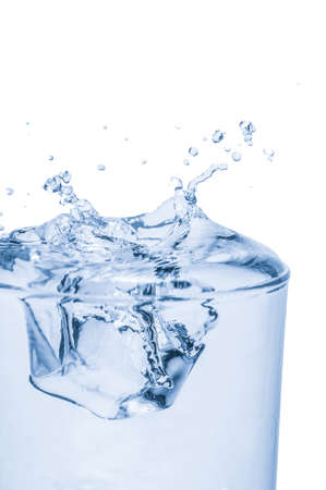 Drop Ice cubes into water, water splashing from glassの写真素材