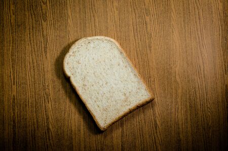 sliced grain bread on wood texture background