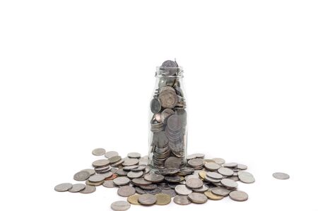 Saving money concept of collecting coins in glass bottle Isolated on white background.の写真素材