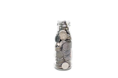 Saving money concept of collecting coins in glass bottle Isolated on white background.の写真素材