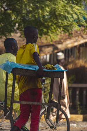 Children hawking food items and goods in the streets of Guider in the Far North Region of Cameroon.