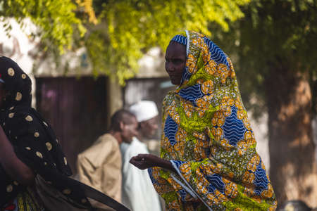 People walking in the streets of Guider mostly dressed in local attires.