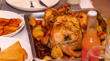 Oven roasted chicken served with potatoes for dinner.の写真素材