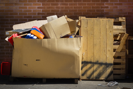 Large Cardboard Garbage Box and Timber Pallets Full of Rubbishの写真素材