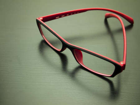 Stylish pink glasses on a dark backgroundの写真素材