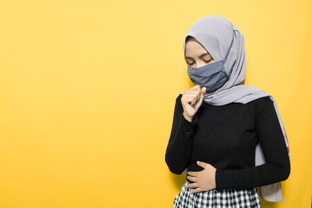 Woman wearing mask and feeling sickの写真素材