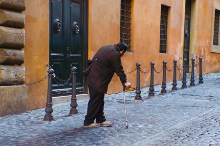 A man is begging for charity in the street.の写真素材