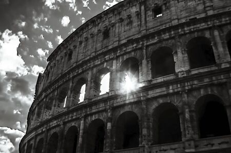 Artistic sun through the Colosseum