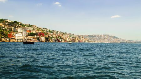 View from the sea of Posillipo hill, Naples and the blue waters of the Gulf of Naplesの写真素材