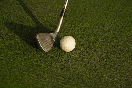 Club about to hit a golf ball