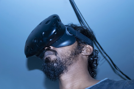 Indian looking man using VR technology