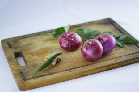 Fresh ingredients for cooking with onions, ginger and curry leaves.の写真素材