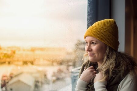 girl looking through windowのeditorial素材