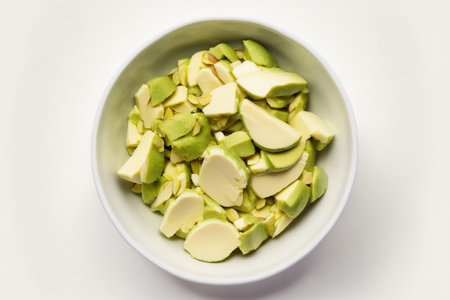 Avocado slices in a bowl, isolated on a white backgroundの素材
