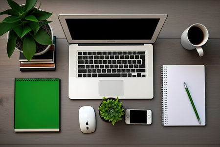 Office supplies and a mock laptop computer are shown on a deskの素材