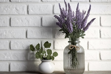 Lavender in glass vase against white brick wall. Farmhouse shabby chic. Provence interiorsの素材