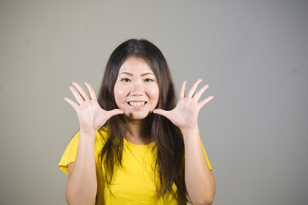 young beautiful and happy Asian Korean woman smiling cheerful posing natural and fresh on isolated background in fun and happiness emotion and joyful face expression の写真素材