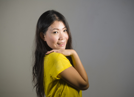 young beautiful and happy Asian Korean woman smiling cheerful posing natural and fresh on isolated background in fun and happiness emotion and joyful face expression の写真素材