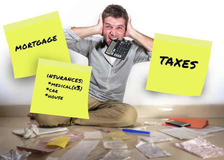 monthly expenses  notes and business man screaming desperate and overwhelmed calculating debt stressed about money payments and bills in domestic finance problem conceptの写真素材