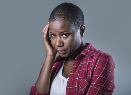 lifestyle isolated portrait of young attractive and sad black afro American woman feeling unwell and...