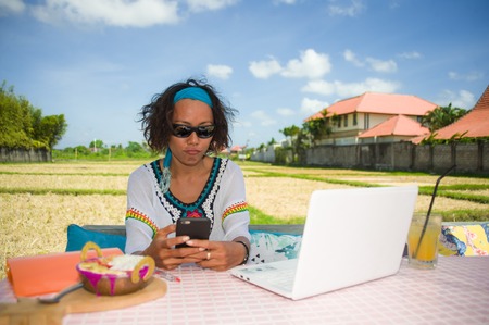 lifestyle outdoors portrait of young happy and attractive afro American mixed ethnicity woman...