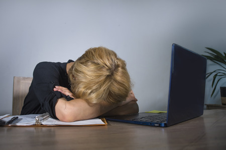 young frustrated and stressed business woman crying sad at office desk working with laptop computer...