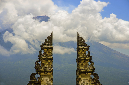 Amazing view of Bali volcano Mount Agung through the beautiful and majestic gate of the hindu Pura Lempuyan temple of Indonesia in Asia holidays travel destination conceptの写真素材