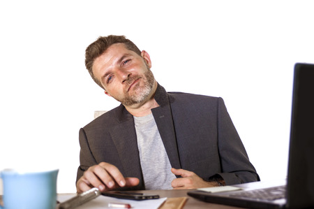 isolated portrait of young successful and attractive businessman working at office computer desk...