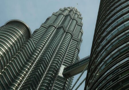 KUALA LUMPUR / MALAYSIA - JANUARY 2019 : View of the impressive Petronas twin towers and bridge at...