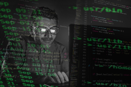 weird tidy and nerd hacker man in big glasses programming and hacking laptop computer system...
