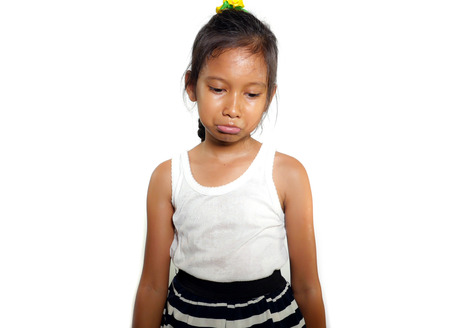 portrait of 8 or 9 years old sweet sad and upset mixed ethnicity child feeling unhappy posing moody...