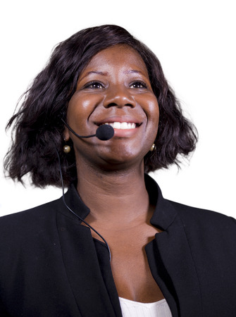young attractive and confident business woman with microphone headset speaking to audience in...