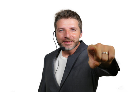 young attractive and confident successful man with headset speaking at corporate business coaching and training auditorium conference room talking giving motivation training isolated on whiteの写真素材