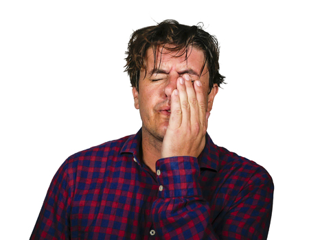 dramatic portrait of stressed and overwhelmed 30s or 40s man holding head with hands in crazy stress...