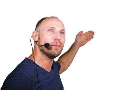 happy attractive and confident businessman speaker with headset giving coaching conference training for business success smiling cheerful and positive in casual code isolated on studio backgroundの写真素材