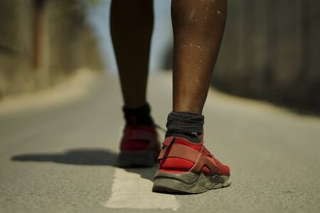 urban runner workout . Back view in detail of athletic black African American sport man legs and...
