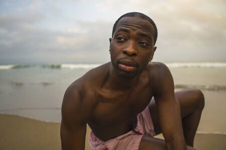 contemporary dance choreographer and dancer doing ballet beach workout . a young attractive and athletic black African American man dancing on sunrise doing dramatic performanceの写真素材