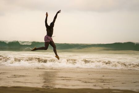 dramatic contemporary dance choreographer doing ballet beach workout . young attractive and athletic...