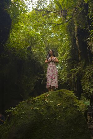 beautiful dreamy portrait of young attractive and elegant Asian woman in Summer dress enjoying...