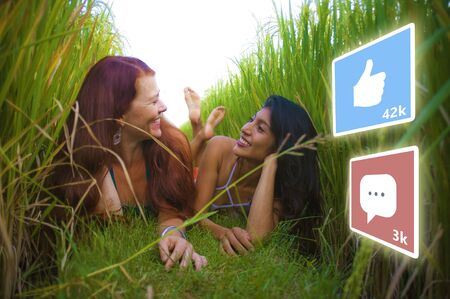 app likes and comments feed composed with young successful and happy tourist girls taking girlfriends selfie together in beautiful tropical landscape in digital nomad social media influencer conceptの写真素材