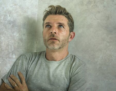 dramatic portrait of middle aged sad and depressed man in pain feeling stressed and frustrated...