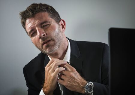 exhausted financial executive man suffering stress - corporate business lifestyle portrait of...